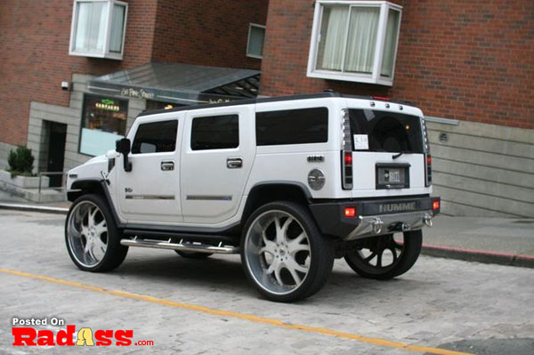 A white hummer parked in front of a building, wondering if they will notice me.