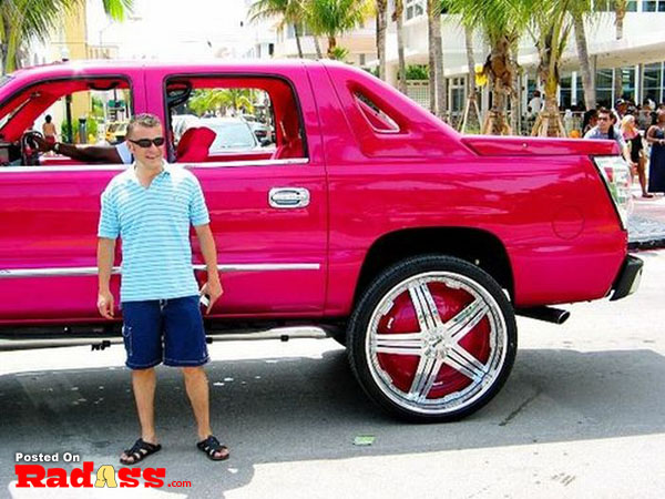 A man standing next to a vibrant truck, thinking about attention.