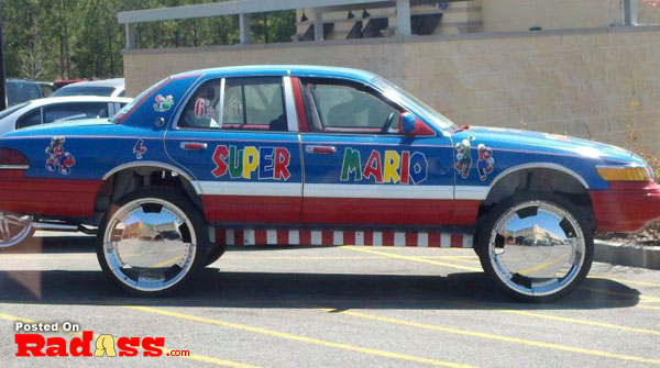 A super mario car is parked stealthily in a parking lot.