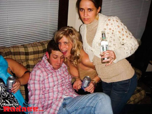 A group of people posing for a picture on a couch.