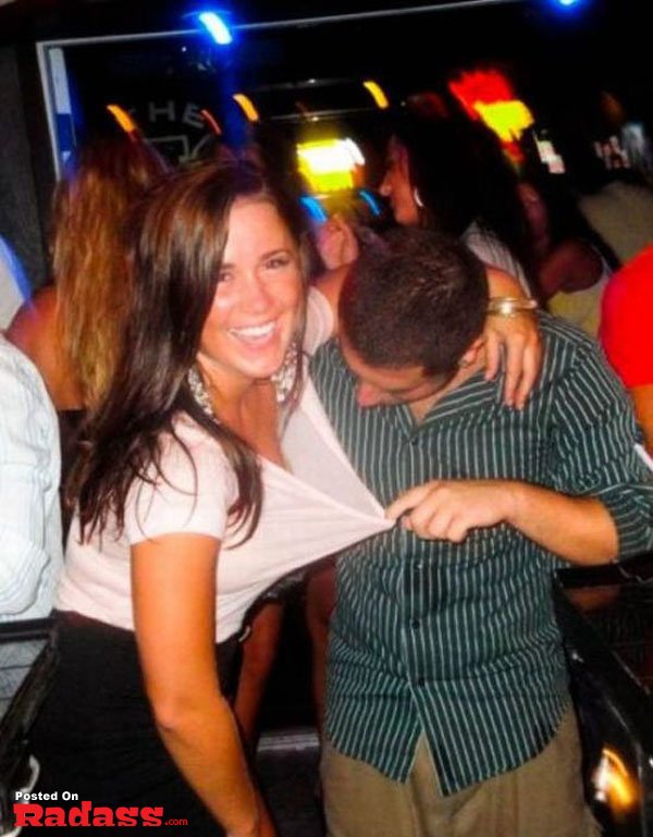 A man and a woman posing for a picture in a bar.