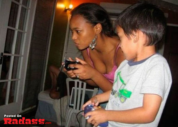 A woman and a boy playing a video game.