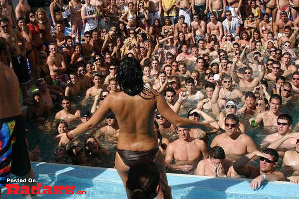 A woman in a bikini standing in front of a crowd
