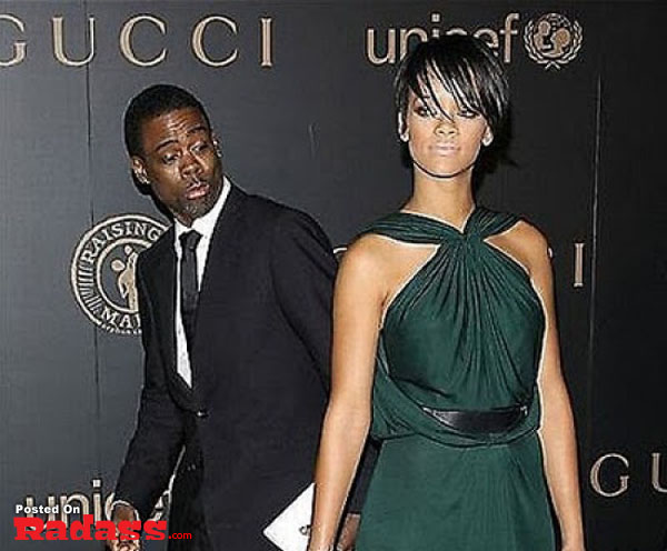 A man and woman photobombing each other on a red carpet.