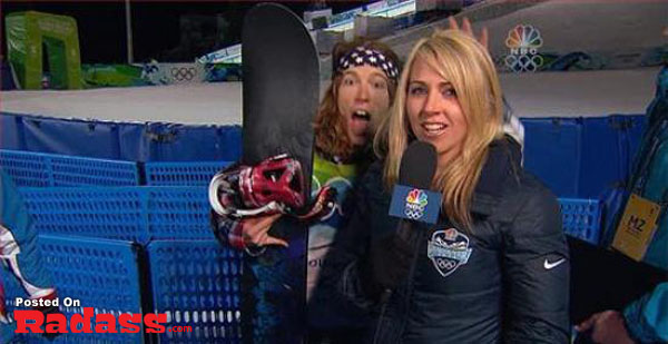 A woman stylishly photobombs while holding a snowboard in front of a camera.