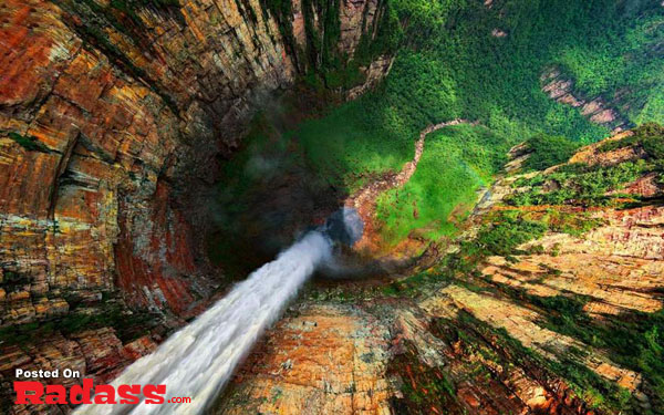 Escape From Civilization: An aerial view of a secluded waterfall nestled in a majestic canyon.