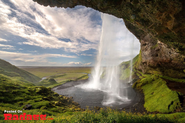 An image capturing the escape from civilization by showcasing a waterfall in Iceland.