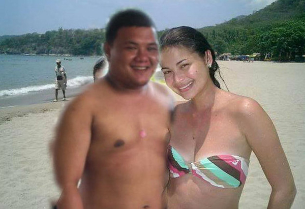 A man with killer Photoshop skills stands next to a woman on the beach.