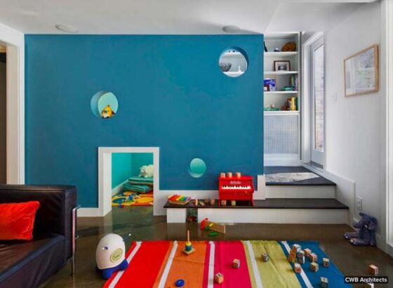 A child's room with a colorful rug.