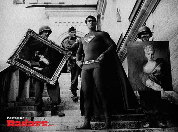 A man in a superman costume holding a painting showcases Super Heroes Throughout History [12 PICS].