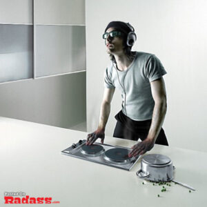 An incredible artist, Christophe Gilbert, captures a man wearing headphones as he creatively mixes food on a kitchen counter.
