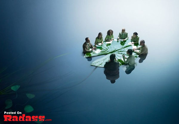 An Incredible Artist captured a group of people sitting around a table in the water.