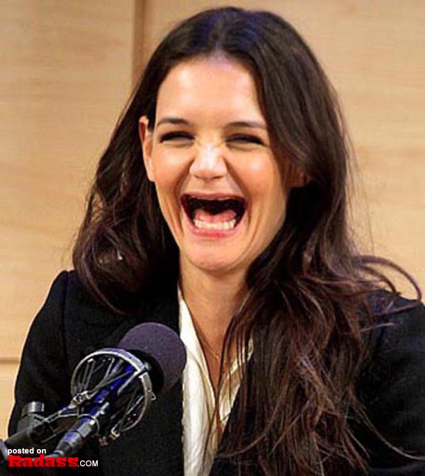 A toothless woman laughing into a microphone.