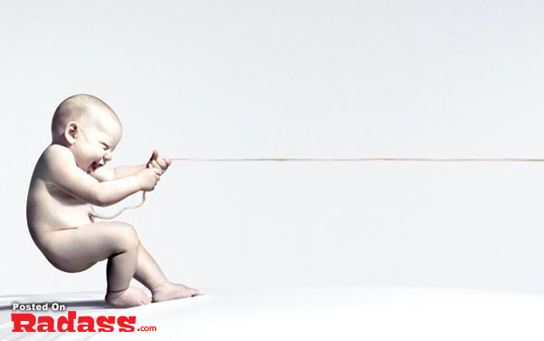 A baby is playing with a string on a white background by an Incredible Artist.