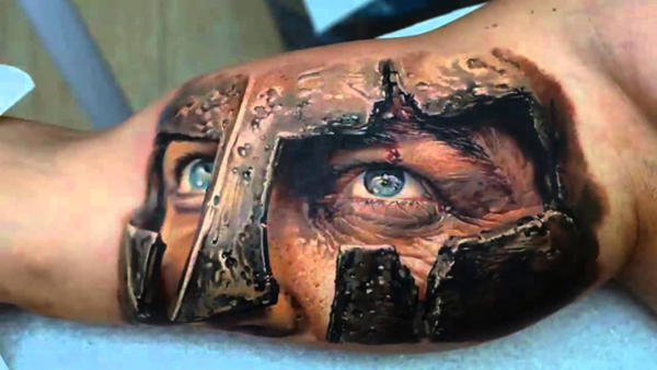 A mind-blowing 3D tattoo of a man with a helmet on his arm.