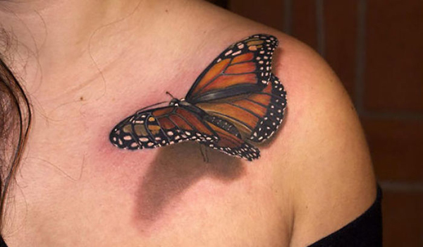A woman boasts a stunning butterfly tattoo on her shoulder that is sure to blow you away.