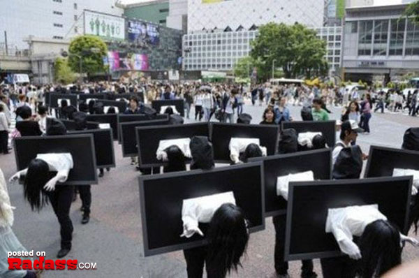 A bizarre procession of individuals dressed in black parades through a bustling Japanese street - WTF Japan!