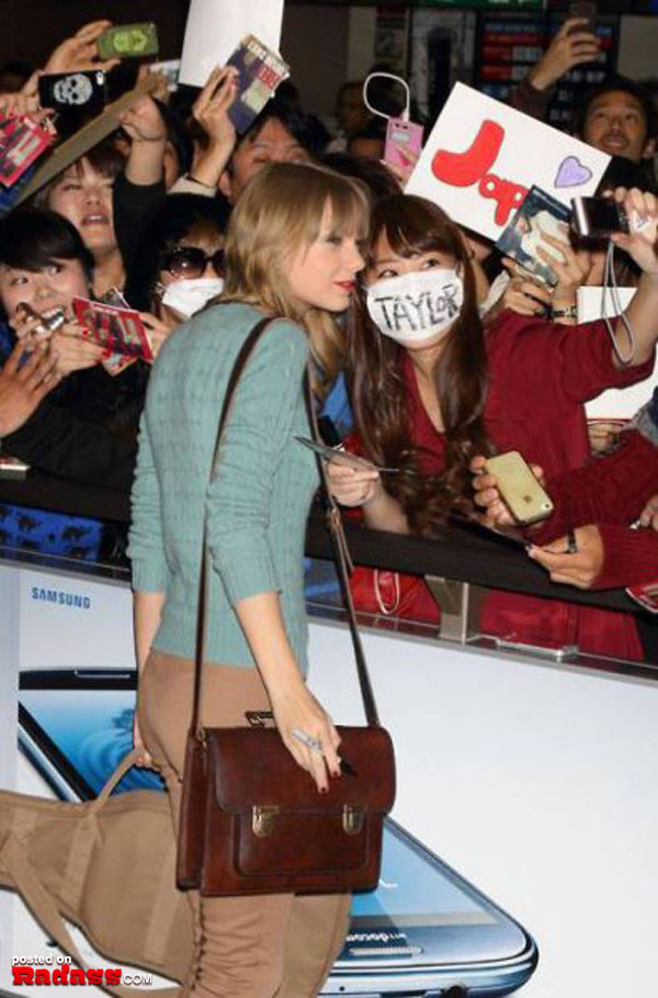 Taylor Swift is surrounded by fans at a WTF Japan event.