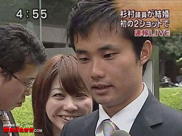 A man in a suit and tie is talking to the camera in Japan.