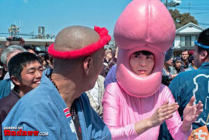 A woman in a WTF Japan costume is standing next to a group of people.