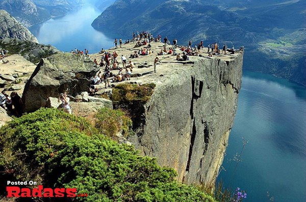 A group of people on a cliff, preparing to check off items from their bucket list.