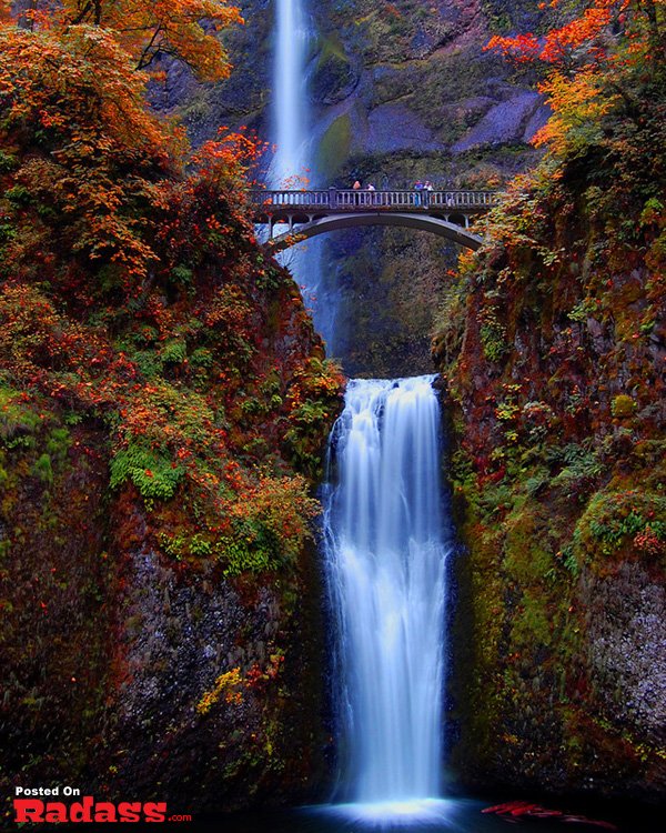 A bridge over a majestic waterfall, adding to your bucket list of breathtaking sights to see.