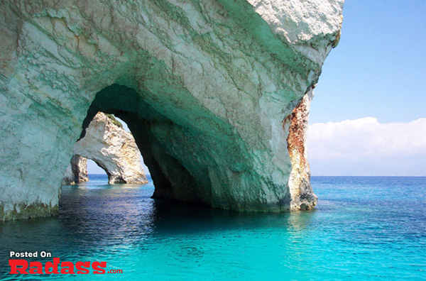 A water cave with clear blue water.