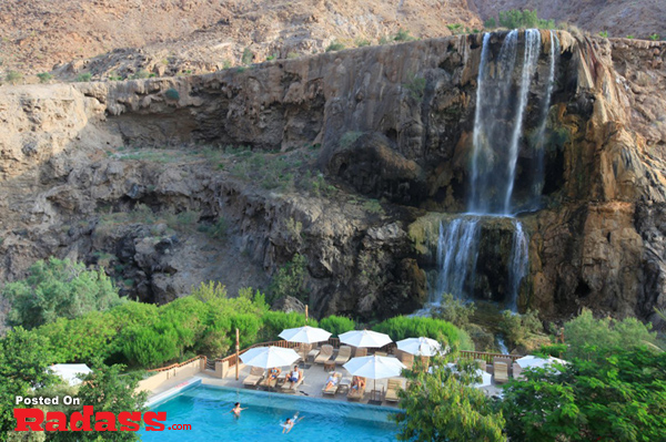 A bucket list destination featuring a stunning swimming pool with a captivating waterfall backdrop.