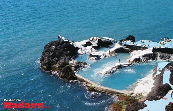 A pool on a rock in the ocean.