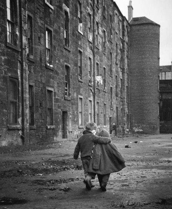 Two children walking down a street with buildings in the background, When We Reminisce, Life Feels More Meaningful.