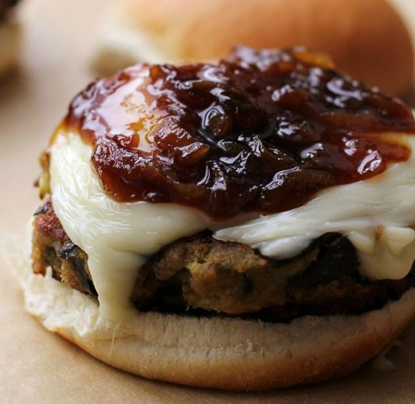 A cheeseburger topped with tangy sauce, perfect for Awesome Burger Ideas in 2022.