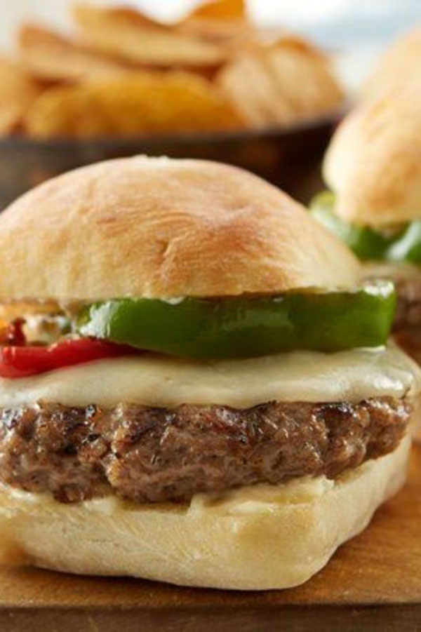 2022 Awesome Burger Ideas: Hamburger sliders with peppers and cheese showcased on a cutting board.