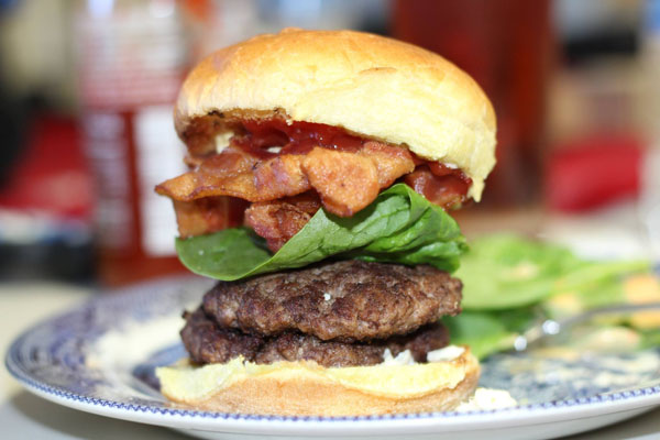 A bacon and spinach-topped burger ready to impress with its deliciousness and uniqueness - truly an awesome burger idea for 2022!