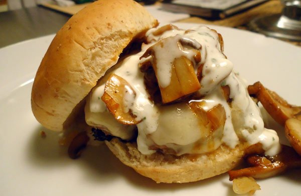 An enticing burger placed on a clean, white plate.