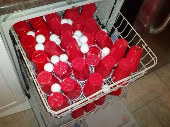 A dishwasher full of red and white cups, symbolizing the college struggle.