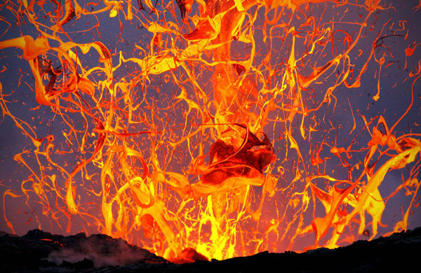 Lava erupts from a volcano in cool Hawaii.