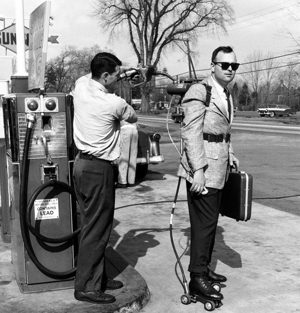 Two men standing next to a gas pump in one of the 40 cool pics.
