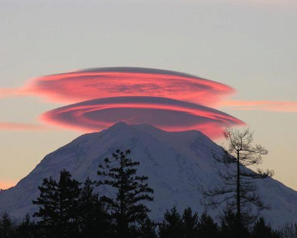 A stunning spherical cloud hovers over a majestic mountain at sunset, offering one of the 40 cool pics to brighten your day.