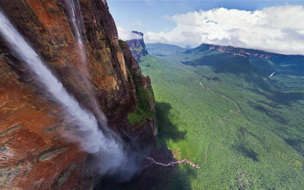 An aerial view of a breathtaking waterfall in the mountains.