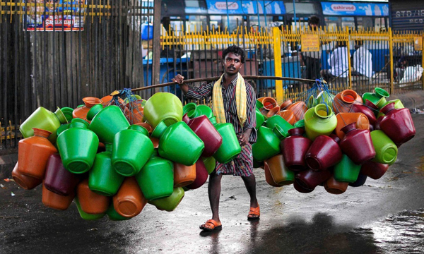 A man carrying an abundant number of water jugs offers plenty of cool pics to brighten your Saturday.