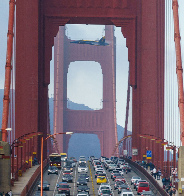 A plane flying over the Golden Gate Bridge, offering plenty of cool pics.