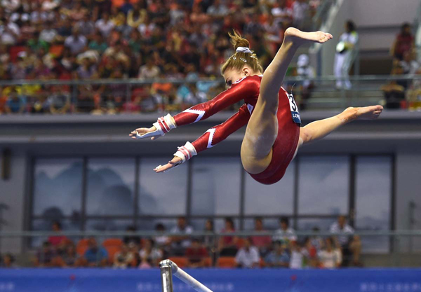 A female gymnast showcasing her skills on the uneven bars, with plenty of cool pics to brighten your Saturday.