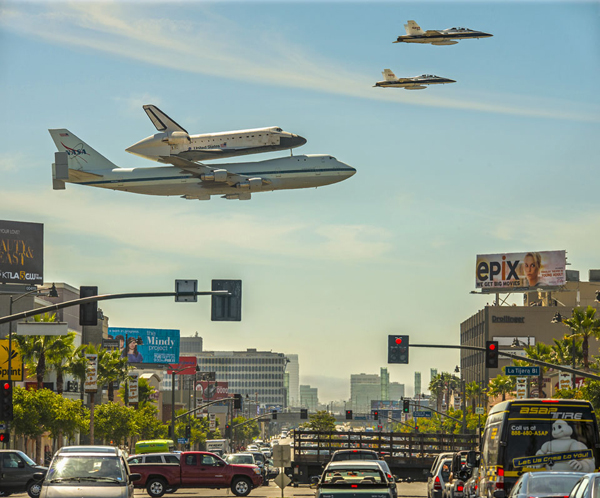 A space shuttle flying over a city street, offering plenty of cool pics to brighten your Saturday.