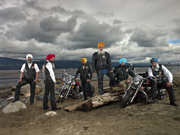 A group of motorcycle riders posing for some cool pics.