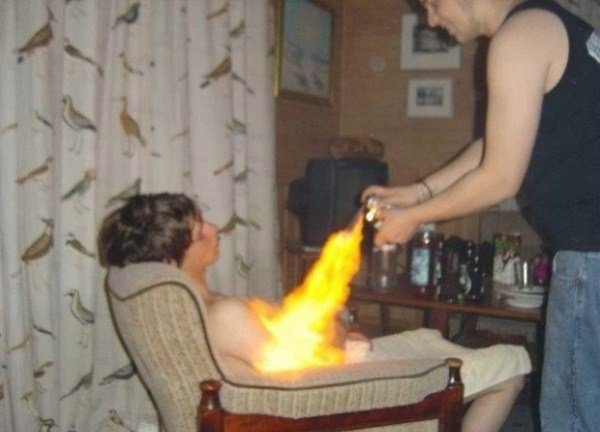 A man, drinking excessively with friends, sets fire to a chair.
