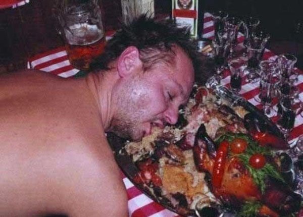 A man sleeping with excess food.