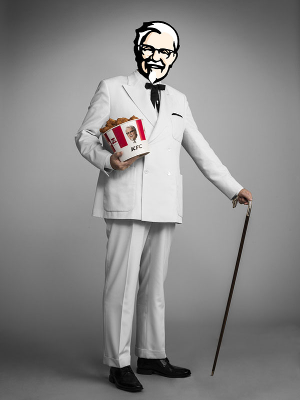 The New Colonel Sanders, dressed in a white suit, poses confidently with a cane in hand as he gets photoshopped.