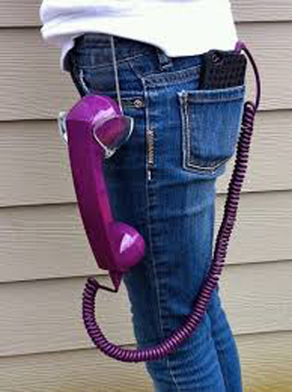 A hipster woman wearing jeans and a purple phone holder.