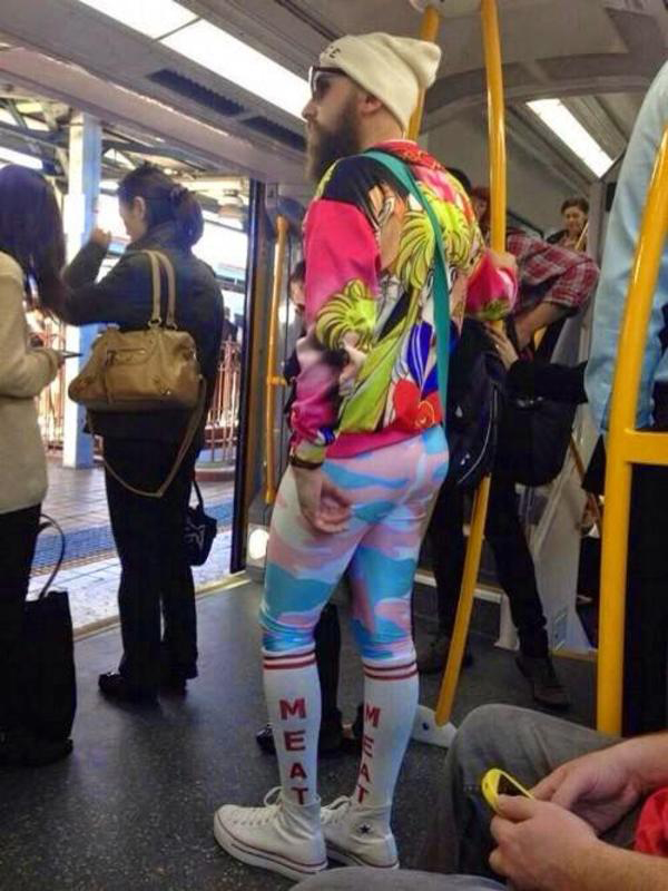 A man on a subway wearing colorful leggings, proving that hipsters have gone too far.