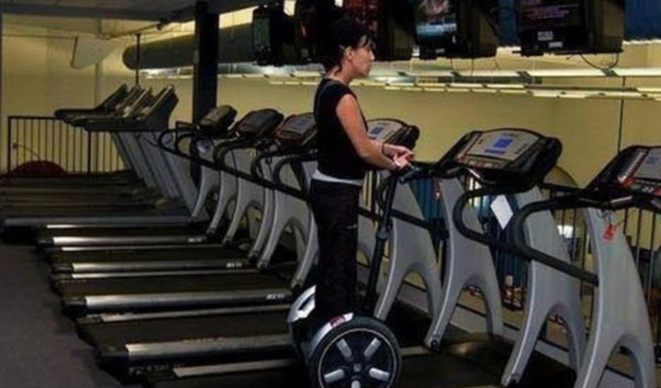 A woman working out on a treadmill at a gym.